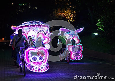 Illuminated decorated trishaw with soft toys at night in Malacca, Malaysia Editorial Stock Photo