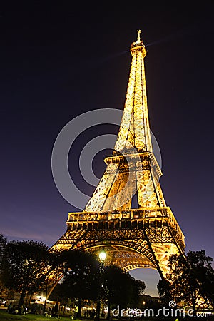 Illuminated Eiffel Tower at night in Paris Editorial Stock Photo