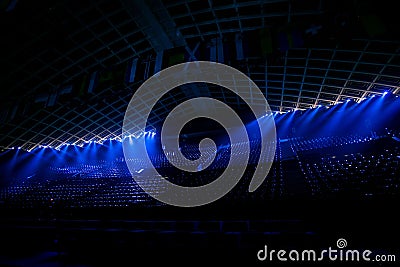 Illuminated empty blue stadium with a large stage Stock Photo
