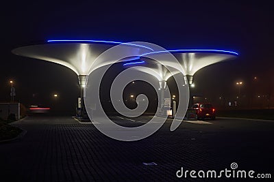 Illuminated futuristic gas station at night Stock Photo