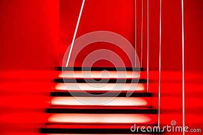 Illuminated futuristic staircase in red neon lights Stock Photo