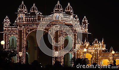 Illuminated gate of Mysore city palace at night Stock Photo