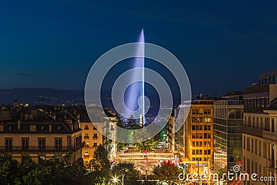 Illuminated Geneva Water Fountain Jet d`Eau - the city`s most famous landmark - summer evening view with blue sky, Geneva, Editorial Stock Photo