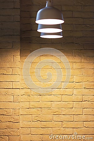 Illuminated grunge yellow brick wall background Stock Photo