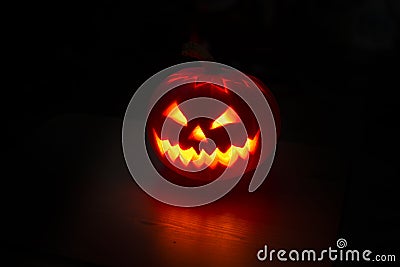 Illuminated halloween pumpkin on black background Stock Photo