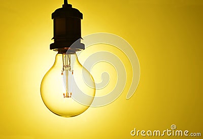 Illuminated hanging light bulb Stock Photo