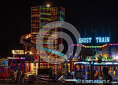 Illuminated, helter skelter ride at a funfair. 3 Editorial Stock Photo