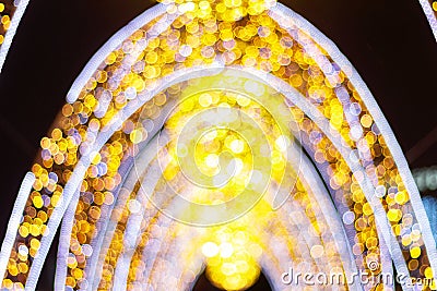 Illuminated holiday arch blurry bokeh Golden moon color Stock Photo