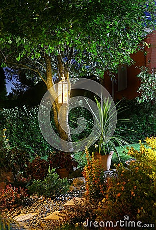Illuminated home garden path patio autumn evening Stock Photo