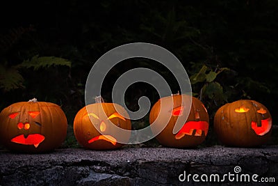 Illuminated Jack-O-Lantern family visiting the Black Forest Stock Photo