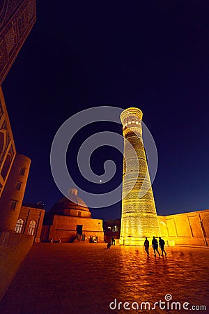 illuminated Kalyan minaret at night in Bukhara Stock Photo