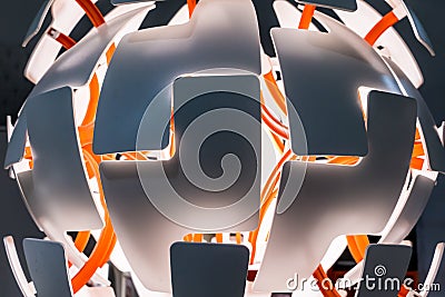 Illuminated multi-layer white lamp with orange structure against Stock Photo