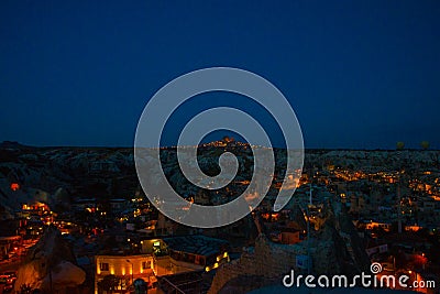 Illuminated at night streets of Goreme, Turkey, Cappadocia. The famous center of flight balloons. Amazing night landscape Stock Photo