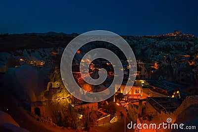 Illuminated at night streets of Goreme, Turkey, Cappadocia. On the horizon - Uchisar. Amazing night landscape Stock Photo