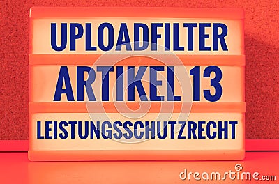 Illuminated panel with the german words Uploadfilter Artikel 13 Leistungsschutzrecht in english Upload filter Article 13 ancillary Stock Photo