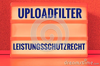 Illuminated panel with the german words Uploadfilter Artikel 13 Leistungsschutzrecht in english Upload filter Article 13 ancillary Stock Photo