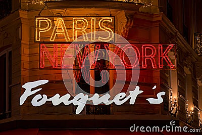 Illuminated Paris New York Fouquet's restaurant brand name on Champs Elysees avenue in Paris Editorial Stock Photo