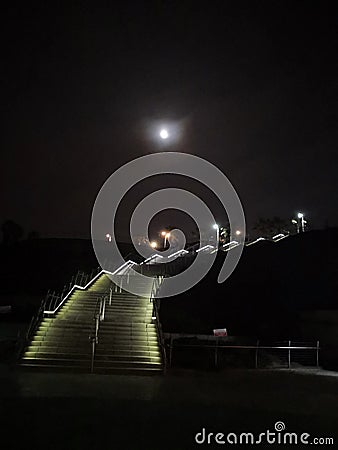 Illuminated stairs at night Stock Photo