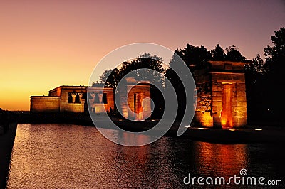 Illuminated Temple of Debod seen at the sunset. Ancient Egyptian temple that was dismantled and rebuilt in Madrid, Spain. Donated Stock Photo