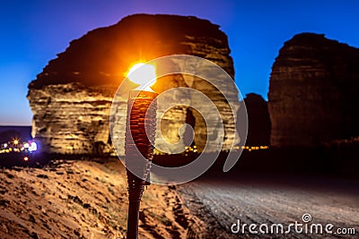 Illuminated by torch sandstone elephant rock erosion monolith standing in the night desert, Al Ula, Saudi Arabia Stock Photo