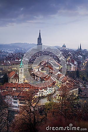 Illuminated view of Bern Old Town at sunset with Bern Minster and Nydeggkirche Church - Bern, Switzerland Stock Photo