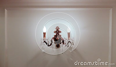Illuminated Vintage Style Lamp Hanging on White Wooden Wall Stock Photo
