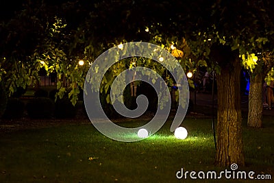 Illumination backyard light garden with electric ground lantern. Stock Photo