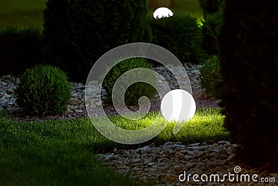 Illumination backyard light garden with electric ground lantern. Stock Photo