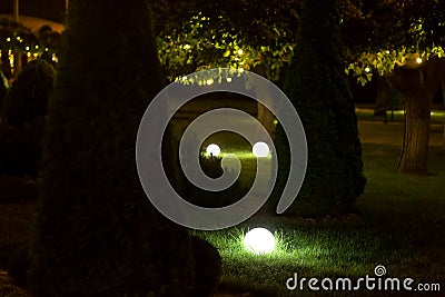 Illumination landscape light backyard with electric ground lantern with round diffuser lamp. Stock Photo