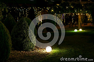 Illumination landscape light park with electric ground lantern. Stock Photo