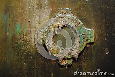 Illuminator on a rusty metal wall. Stock Photo