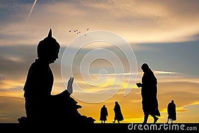 Buddhist monks at the temple at sunset Stock Photo