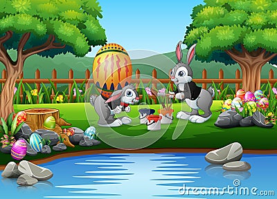 Happy bunnies painting a large easter egg Vector Illustration