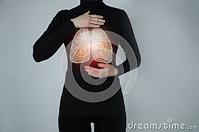 Illustration of lungs detox with highlighted organ and contrast hands on dark background. Stock Photo