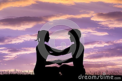 Man and woman doing yoga at sunset Stock Photo