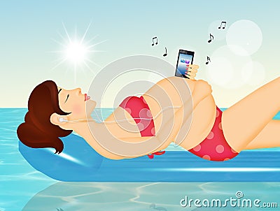 Pregnant woman listens to music on the air mattress Stock Photo