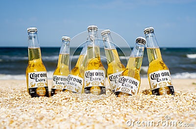 Illustrative editorial of Corona beer bottles on the beach sand: GENICHESK, UKRAINE - 19 June 2021 Editorial Stock Photo