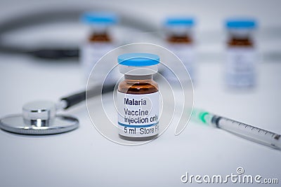 Illustrative picture of malaria vaccine vial with syringe and stethoscope Stock Photo