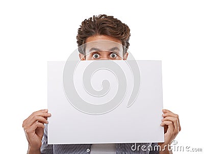 Im 100 behind your product. Portrait of a handsome young man peering over a sign for your copyspace. Stock Photo