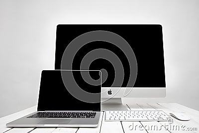 MacBook laptop and iMac computer Editorial Stock Photo