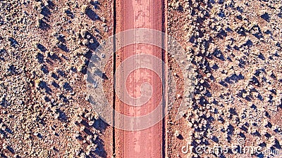 Aerial looking down at red sandy desert road in plains Stock Photo