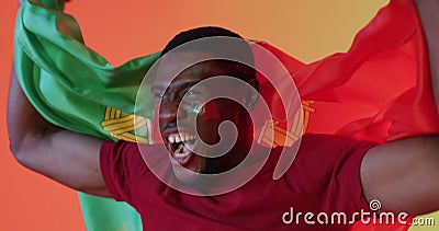 Image of african american male supporter with flag of portugal over confetti Stock Photo