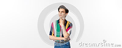 Image of angrodynous young man looking at upper left corner thoughtful, reading promo, standing over white background Stock Photo