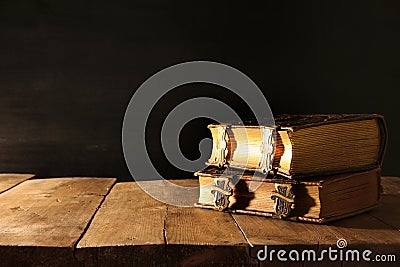 Image of antique books, with brass clasps on old wooden table Stock Photo