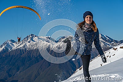 Image of attractive young woman flinging the snowball Stock Photo