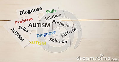 Image of autism text over heart formed with autism awareness puzzles on white Stock Photo