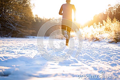 Image from back of man in sportswear, red cap on run in winter Stock Photo