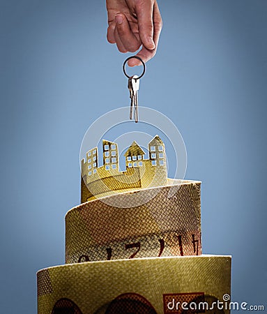 Image of a banknote with a cut out on it houses and a hand holding a bunch of keys. Stock Photo