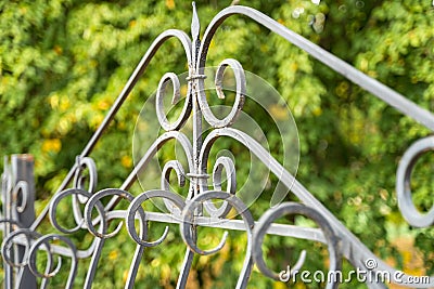 Image of a Beautiful decorative cast iron wrought fence with artistic forging. Metal guardrail close up. Stock Photo