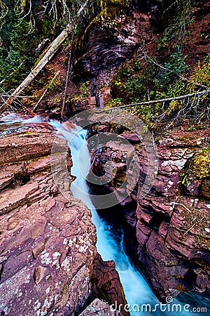 Beautiful lichen rock gorge with water rushing Stock Photo